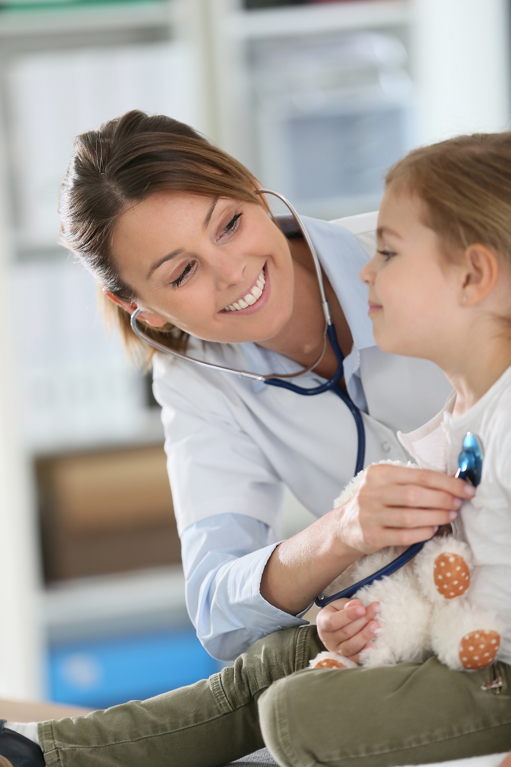 Doctor examining little girl with stethoscope - Saddleback Pediatric Care