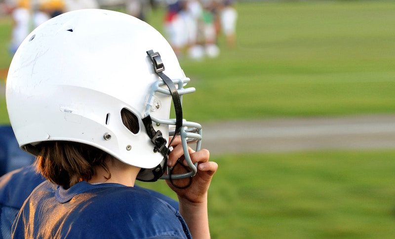 football player in helmet at risk for concussion